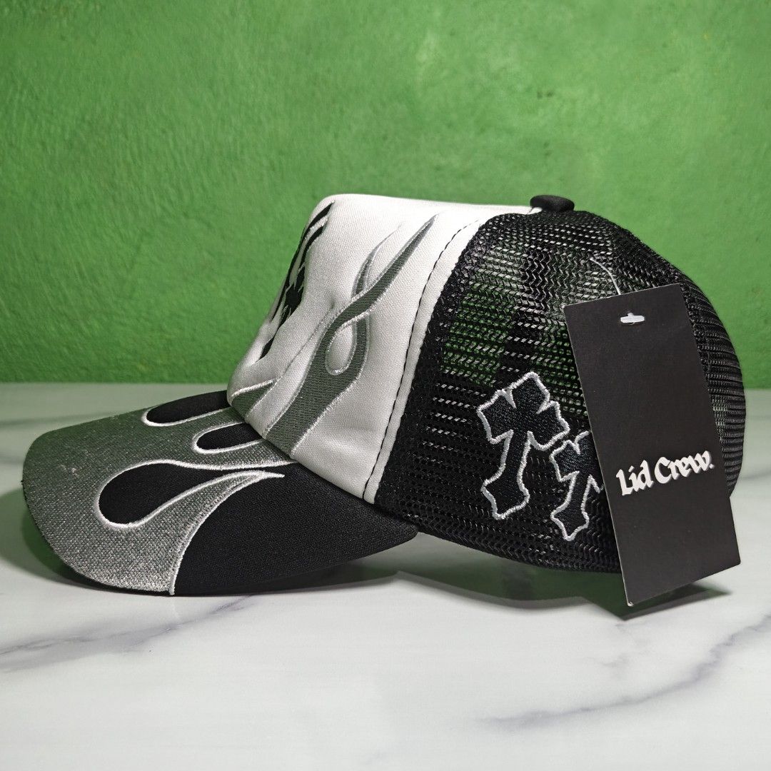 Lid Crew NY Yankees Flame Trucker Hat (Category: Caps & Hats) located in Dasmarinas. Submitted by nifty_n00k (Listing ID 1463327689, Image 2). Description: - Black and white trucker hat - Features flame embroidery - Includes NY Yankees logo and cross details - Breathable mesh back - Adjustable strap for a custom fit - Ideal for casual wear.