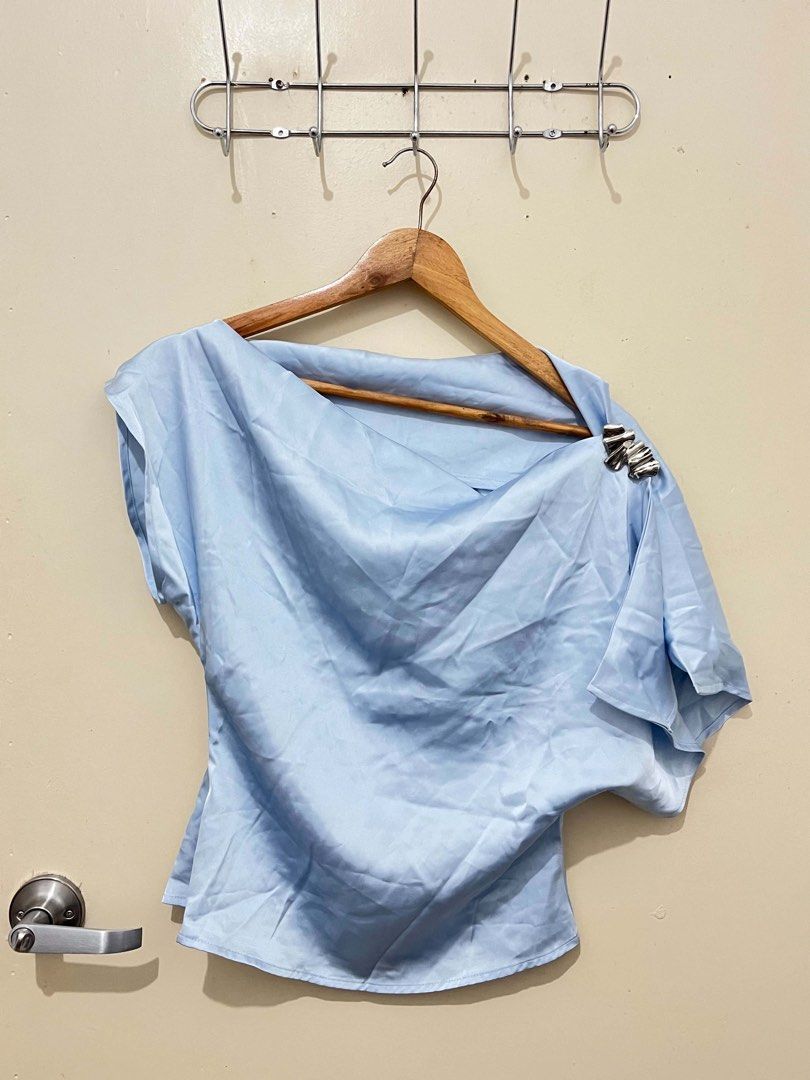 Light Blue One Shoulder Top with Silver Detail (Category: Sleeveless) located in Malolos. Submitted by vanderwoodsen_ (Listing ID 1463424650, Image 1). Description: - Light blue one-shoulder top - Unique silver accent on shoulder strap - Fabric with a slight sheen - Flowy, drapey style - Perfect for dressing up or down.