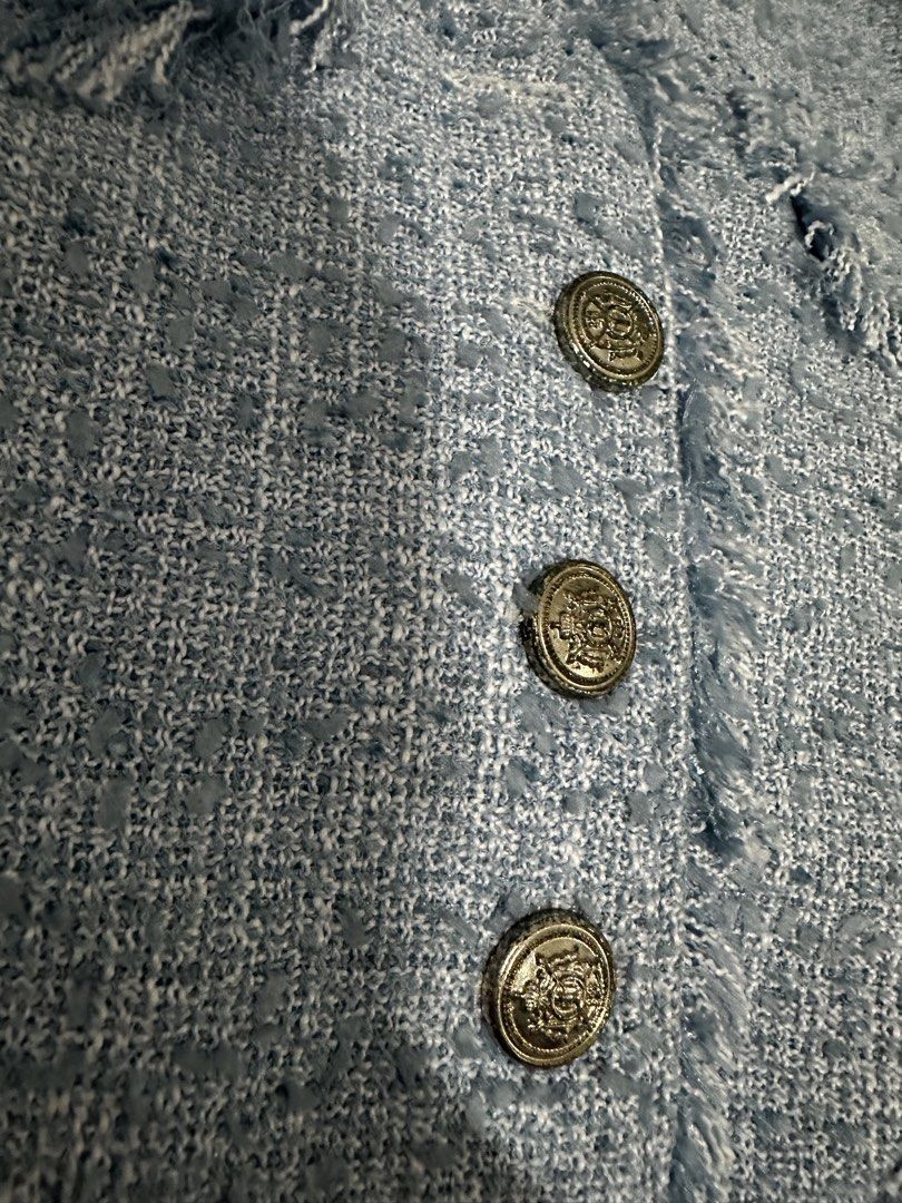 Light Blue Tweed Jacket with Buttons (Category: Coats, Jackets and Outerwear) located in Manila. Submitted by everythingsale101 (Listing ID 1463477548, Image 2). Description: - Light blue cropped tweed jacket - Features frayed edges - Fully lined interior - Versatile: pairs well with jeans or skirts - Ideal for spring or fall outfits - Creates a chic, put-together look Fits M-L (up to 38 bust) Issue: button details see pics (issue: lightly tarnis