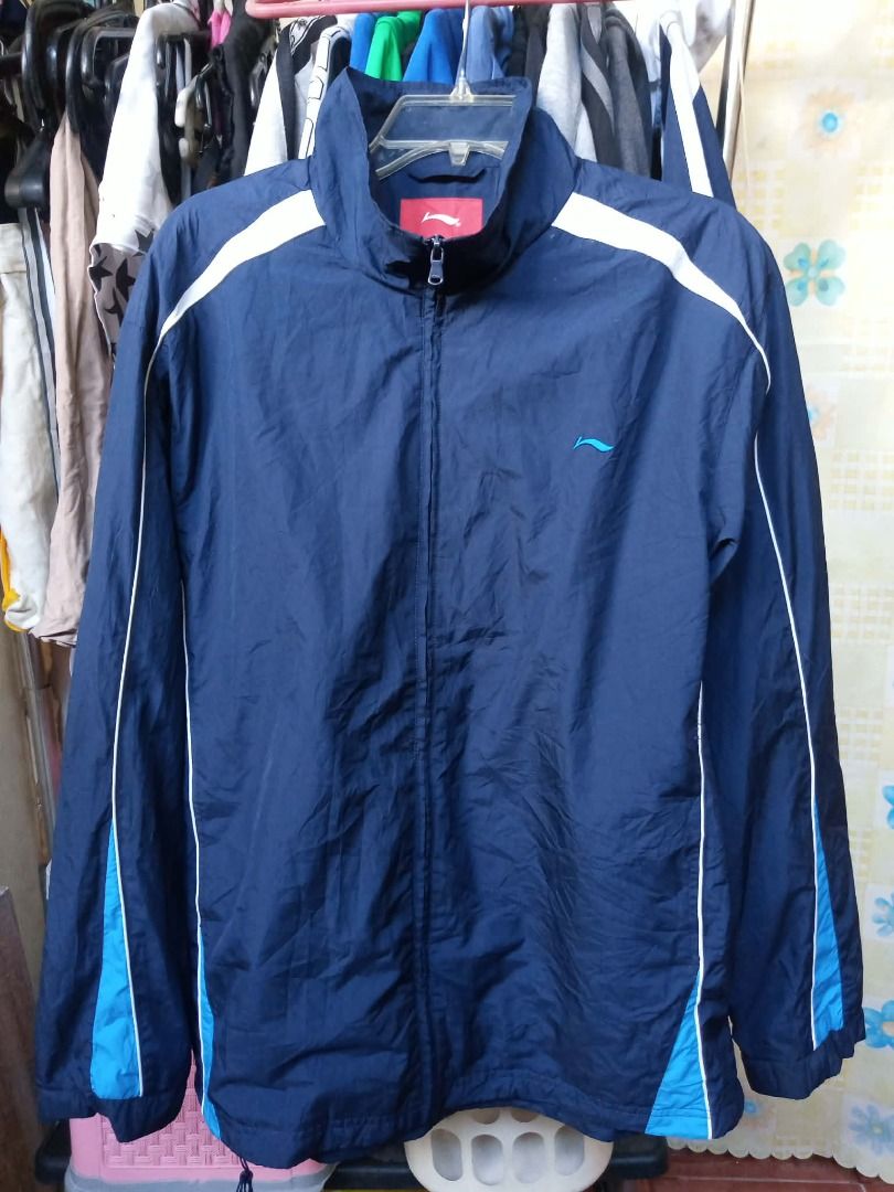 windbreaker Li-Ning (Category: Coats, Jackets and Outerwear) located in Pasig City. Submitted by rjkfindsofficial (Listing ID 1463411630, Image 2). Description: - Li-Ning Windbreaker - Color: Navy Blue with White & Light Blue Accents - Size: XXL - Dimes L29 x W24 - No issue - Complete tags - Material: 100% Polyester - Features: Full Zip Closure, Stand-Up Collar - Ideal for: Sports and Casual Wear.