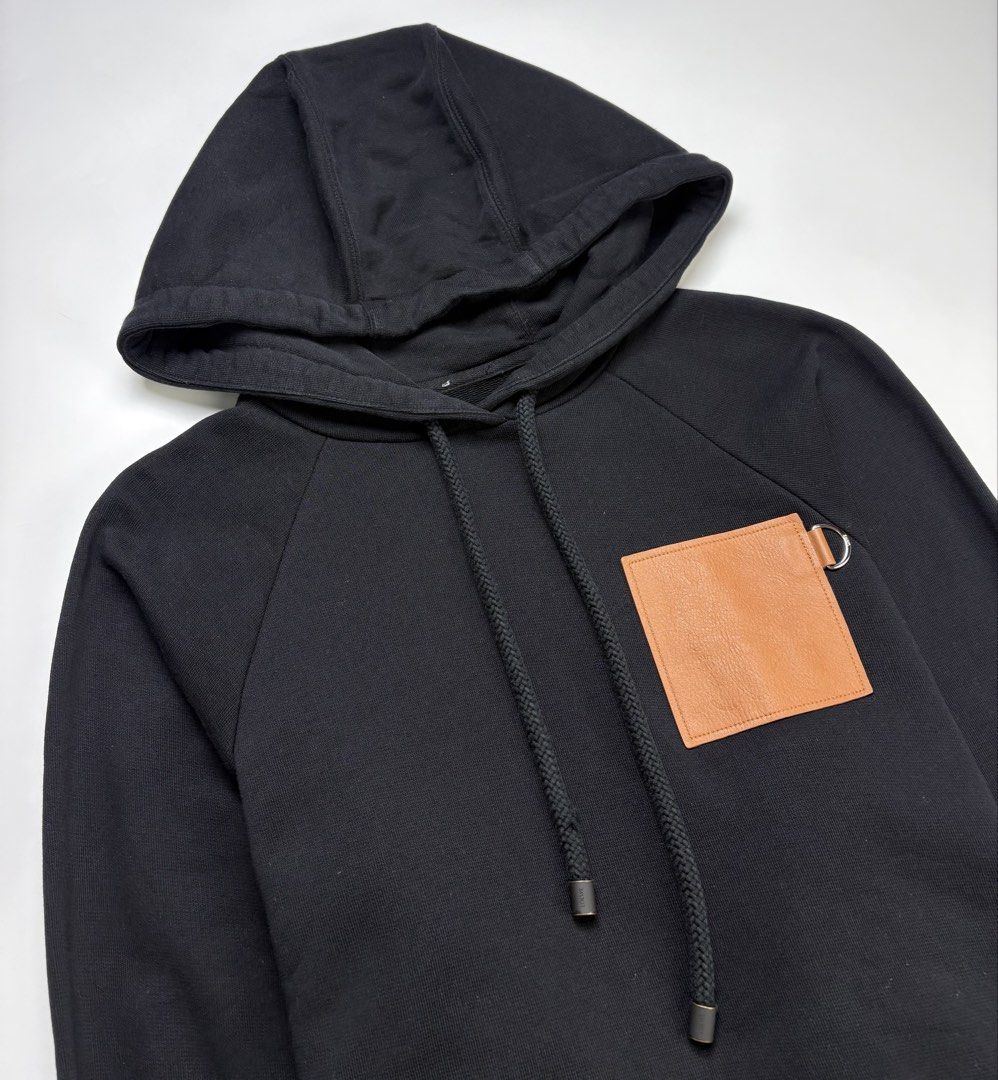 Loewe Leather Anagram Patch Cropped Hoodie (Category: Coats, Jackets and Outerwear) located in Cavite. Submitted by sc_rcity (Listing ID 1463333766, Image 3). Description: Tagged Size : XS Women’s Guaranteed Authentic | Moneyback Guaranteed Like New Flaw : Missing Main Label/Tag , Slight Distressed on the right lace Made in Portugal No Inclusion Characterized by its boxy, cropped silhouette, dropped shoulders, long batwing sleeves, and a prominen