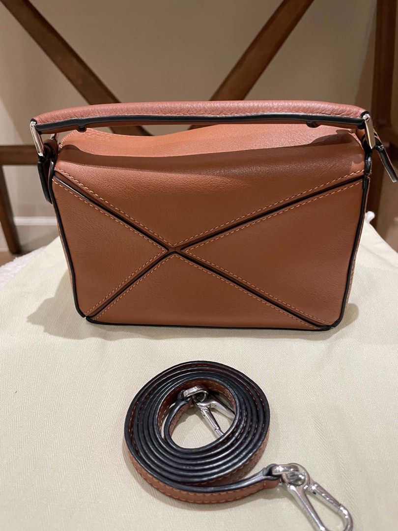 Loewe Puzzle Bag Small Tan Pebble Grain Leather (Category: Luxury Bags & Wallets) located in Davao. Submitted by camillefongty (Listing ID 1463402757, Image 2). Description: - Loewe Puzzle Bag - Color: Tan - Material: Pebble Grain Leather - Size: Small - Features: Detachable shoulder strap - Style: Classic, minimalist, chic - Versatile: Ideal for everyday or special occasions.