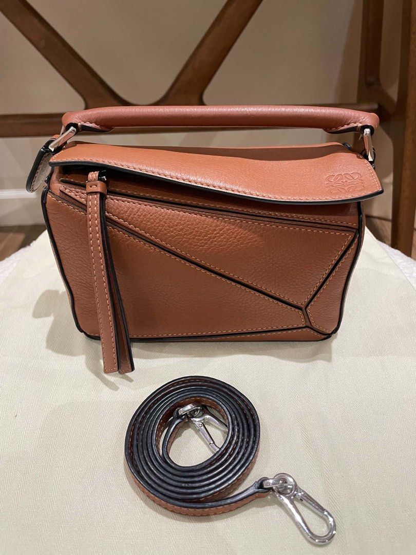 Loewe Puzzle Bag Small Tan Pebble Grain Leather (Category: Luxury Bags & Wallets) located in Davao. Submitted by camillefongty (Listing ID 1463402757, Image 1). Description: - Loewe Puzzle Bag - Color: Tan - Material: Pebble Grain Leather - Size: Small - Features: Detachable shoulder strap - Style: Classic, minimalist, chic - Versatile: Ideal for everyday or special occasions.