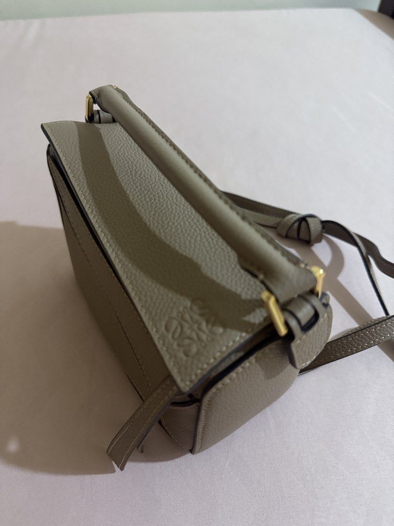 Loewe Puzzle Bag Small Taupe (Category: Luxury Bags & Wallets) located in Manila. Submitted by louisse_iya (Listing ID 1463495563, Image 2). Description: STILL NEGOTIABLE - Color: Taupe - Size: Mini - Hardware: Gold - Features: Detachable shoulder strap - Versatility: Can be carried by hand or worn crossbody.