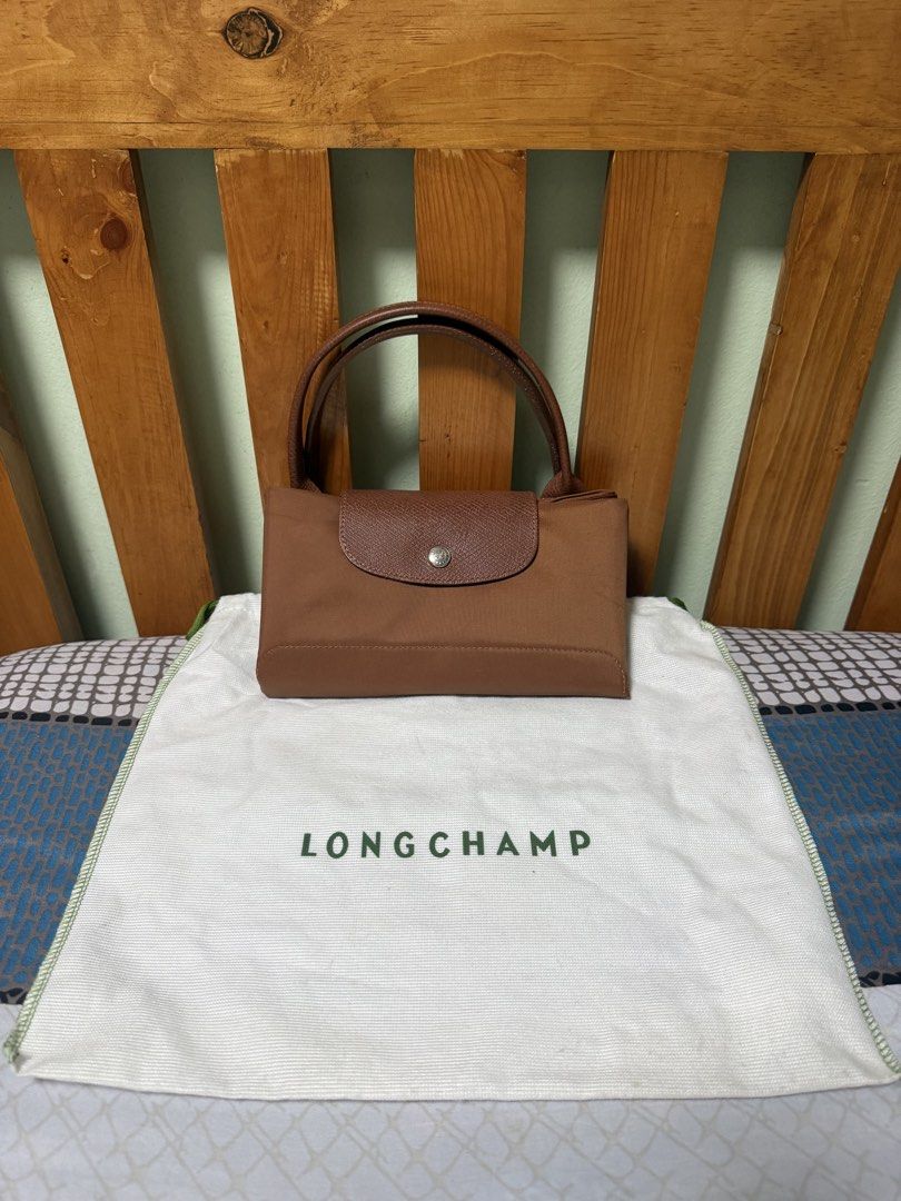 Longchamp Cognac Medium (Category: Luxury Bags & Wallets) located in Las Pinas. Submitted by norlsss (Listing ID 1463472096, Image 2). Description: - Longchamp Le Pliage top-handle bag featuring short leather handles and the signature fold-over flap with a snap closure. - Comes with a dustbag RFS: decluttering.