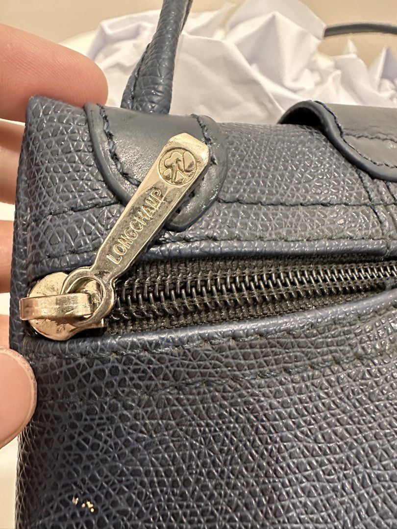 Longchamp Paris Leather Handbag (Category: Luxury Bags & Wallets) located in Bulacan. Submitted by adoseofluxxee (Listing ID 1463505915, Image 3). Description: - Navy blue Longchamp Paris handbag - Made of textured leather - Zip closure with logo flap - Interior zip pocket.