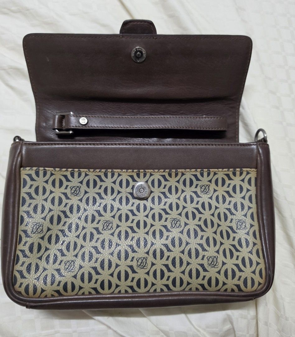 Louis Quatorze Brown Monogram Clutch Bag with Strap (Category: Luxury Bags & Wallets) located in Quezon City. Submitted by blackspider09 (Listing ID 1463479197, Image 3). Description: - Brown leather and monogram canvas clutch - Features Louis Quatorze logo pattern - Magnetic snap closure - Interior zip pocket - Detachable shoulder strap included - Perfect for evenings or travel - Note: Shows some signs of wear on the bottom edges negotiable.