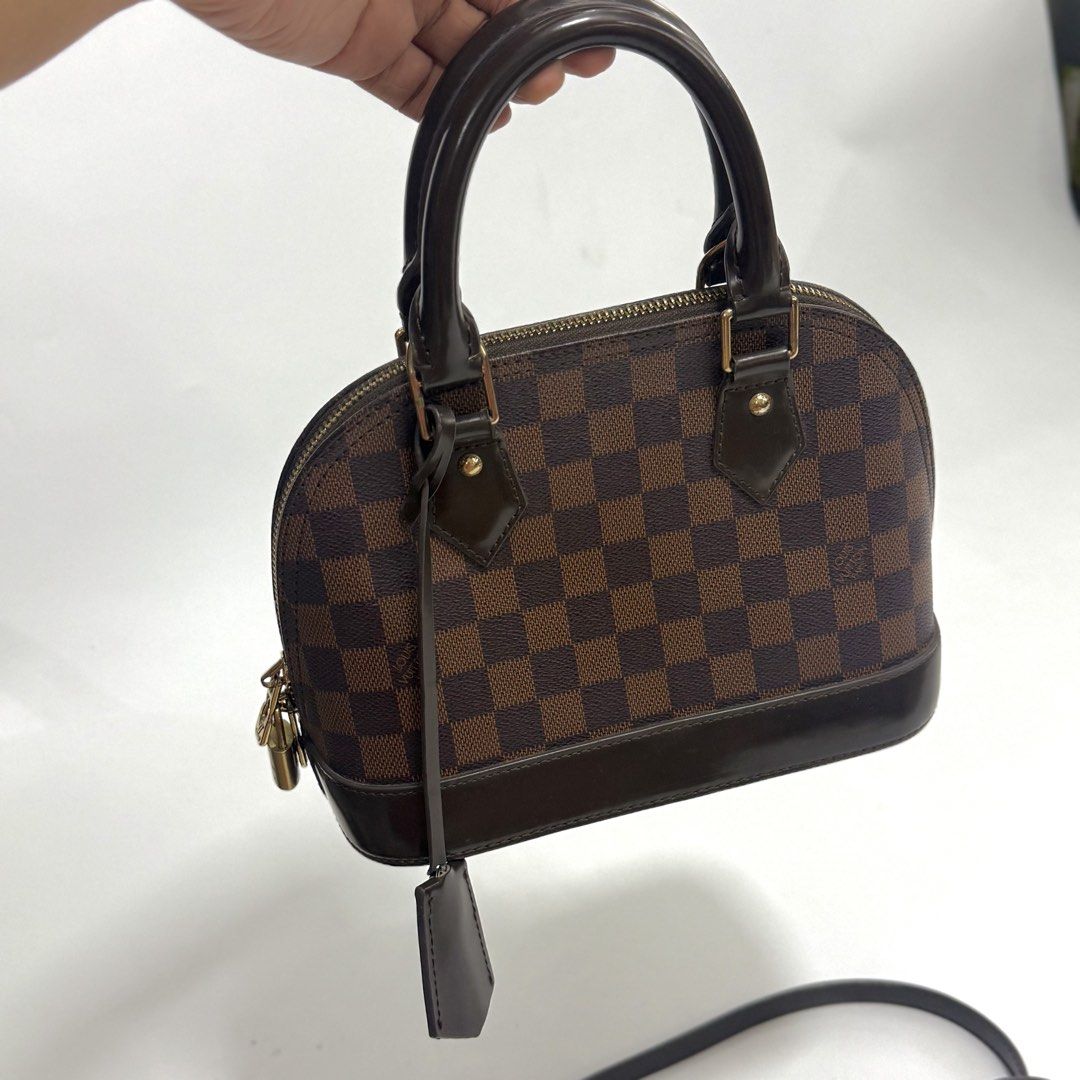 Louis Vuitton Alma BB (Category: Purses & Pouches) located in Pulilan. Submitted by secondary_chives (Listing ID 1463507120, Image 2). Description: in Excellent Condition Includes: long strap, clochette, two keys and padlock • Production Year: 2018 • Measurements: 9.5" L × 4.5" W × 7" H • Interior Pockets: One flat pocket • Handles: Double rolled leather handles and single flat detachable.