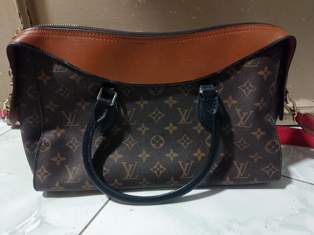 Louis Vuitton Monogram Canvas Leather Trimmed Handbag (Category: Luxury Bags & Wallets) located in Manila. Submitted by sheshe.888 (Listing ID 1463553171, Image 2). Description: - Features classic brown leather trim and handles - Includes a stylish detachable red strap - Elegant gold-tone hardware - Secure zipper closure - Interior is clean and well-maintained - Ideal as a versatile everyday bag.