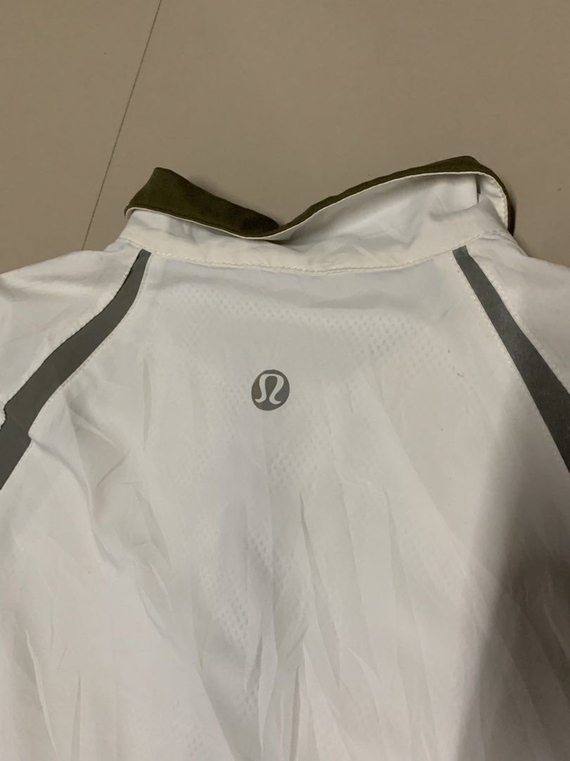Lululemon White & Olive Green Athletic Jacket (Category: Coats, Jackets and Outerwear) located in Cavite. Submitted by good.garments (Listing ID 1463330812, Image 3). Description: - White Lululemon athletic jacket - Olive green accent details - Full zip front with red zipper pull - Reflective grey stripes on sleeves and back - Zippered pocket on the back - Ideal for workouts and casual wear.