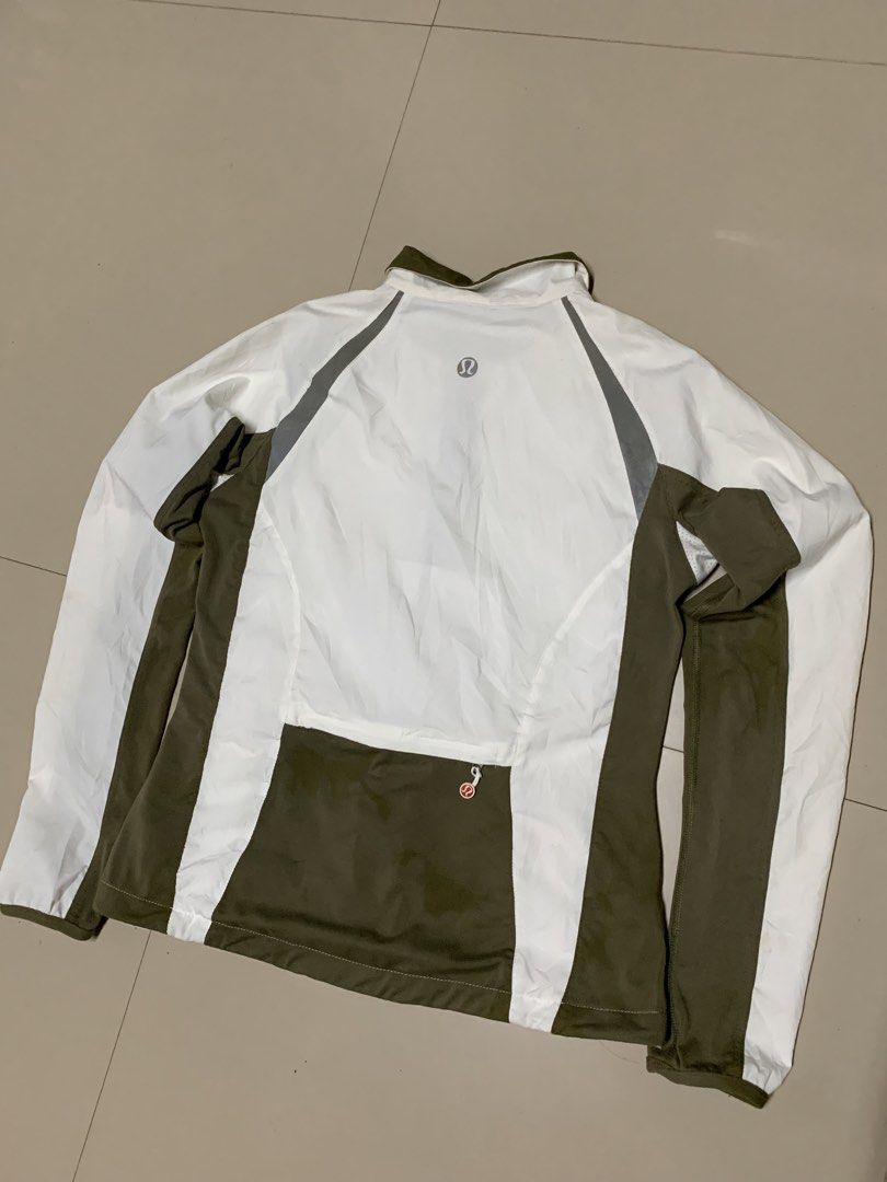 Lululemon White & Olive Green Athletic Jacket (Category: Coats, Jackets and Outerwear) located in Cavite. Submitted by good.garments (Listing ID 1463330812, Image 2). Description: - White Lululemon athletic jacket - Olive green accent details - Full zip front with red zipper pull - Reflective grey stripes on sleeves and back - Zippered pocket on the back - Ideal for workouts and casual wear.