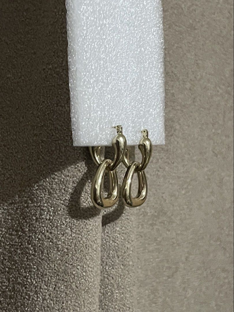 MACY’S Gold Tone Dangle Hoop Earrings (Category: Earrings) located in Talisay. Submitted by mrjannchristian (Listing ID 1463491654, Image 2). Description: - Gold tone dangle earrings - Available in two stylish hoop designs: triangular or linked - Simple and chic aesthetic - Versatile for everyday wear or special occasions - Lightweight and comfortable for all-day wear.