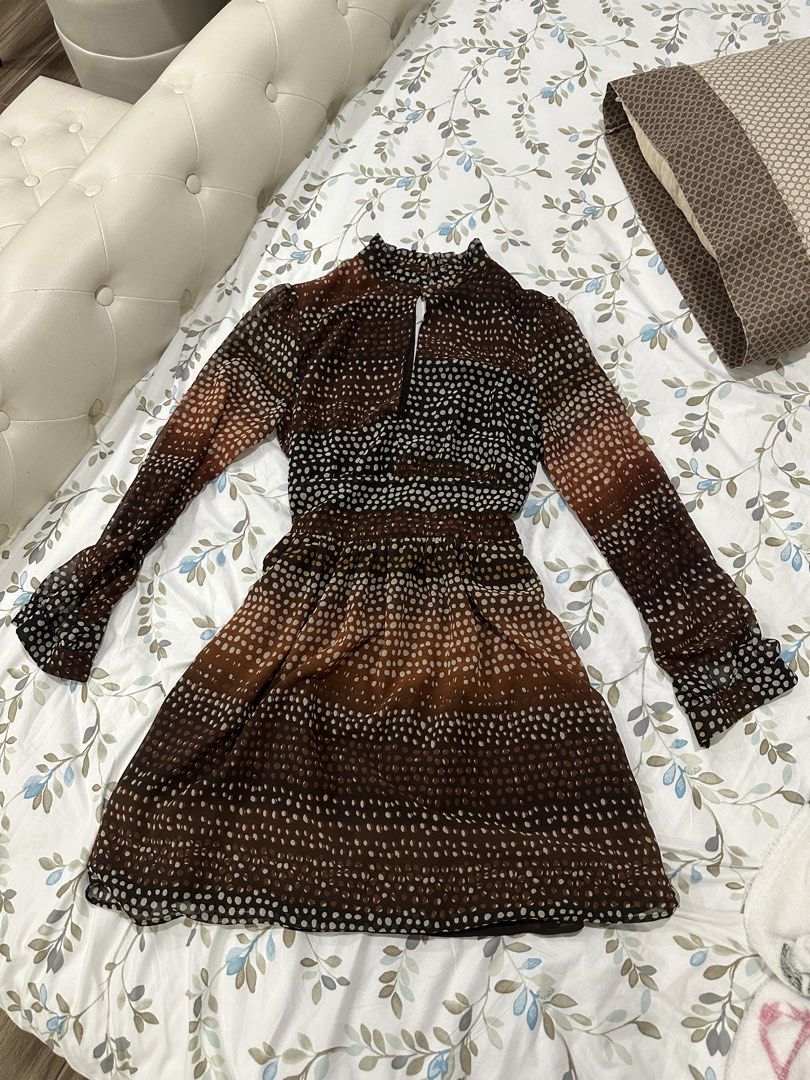 MANGO Dress (Category: Dresses) located in Davao. Submitted by secondlife.authentic (Listing ID 1463471458, Image 1). Description: - Elegant brown dress with a classic polka dot print. - Features long sleeves with stylish ruffled cuffs. - High neckline with a chic keyhole detail at the front. - Comfortable elasticated waist for a flattering silhouette. - Made from a delicate sheer fabric. - Versatile piece: easily dressed up or down for any event