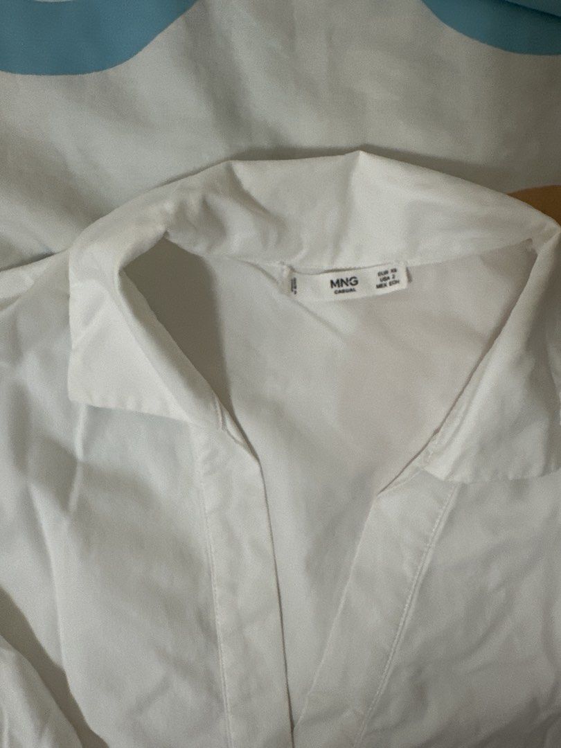 Mango White Collared V-Neck 3/4 Sleeve Shirt (Category: Shirts) located in Manila. Submitted by joan.here (Listing ID 1463408925, Image 2). Description: Brand: mango Size: xs Condition: used but not abused Rfs: decluttering Mop: bank transfer Delivery: grab/ lalamove. Sf shouldered by buyer Loc: tondo manila.
