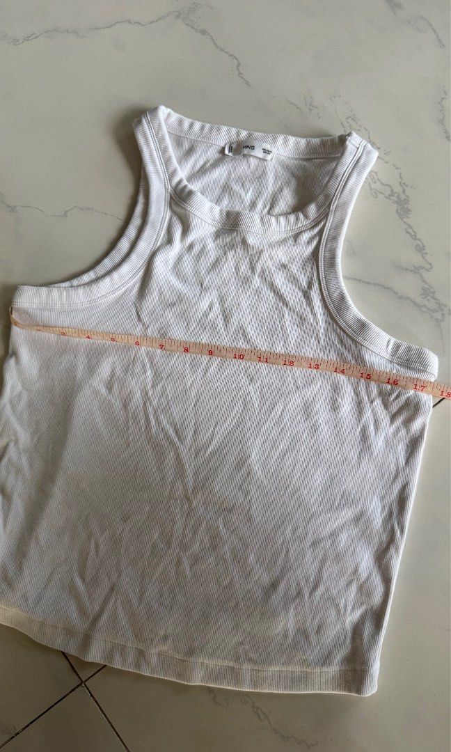 Mango White Ribbed Racerback Tank Top (Category: Sleeveless) located in Manila. Submitted by patc20 (Listing ID 1463368545, Image 3). Description: - Brand: MNG - Style: Ribbed Racerback Tank Top - Color: White - Material: Stretchy fabric - Measurements: Approx. 17 inches width, 23 inches length - Features: Versatile basic piece, easy to pair with jeans or skirts.