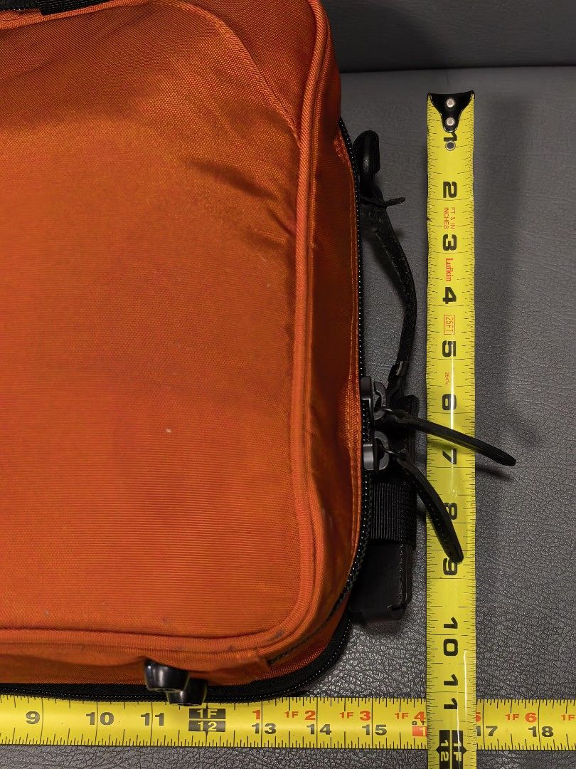 Manhattan Passage Orange Bag (Category: Cross-body Bags) located in Cagayan de Oro. Submitted by pootx (Listing ID 1463484364, Image 2). Description: - Manhattan Passage orange bag - Multiple interior compartments for organization - Padded shoulder strap for comfort - All zippers intact and functional - Approximately 10 inches tall.