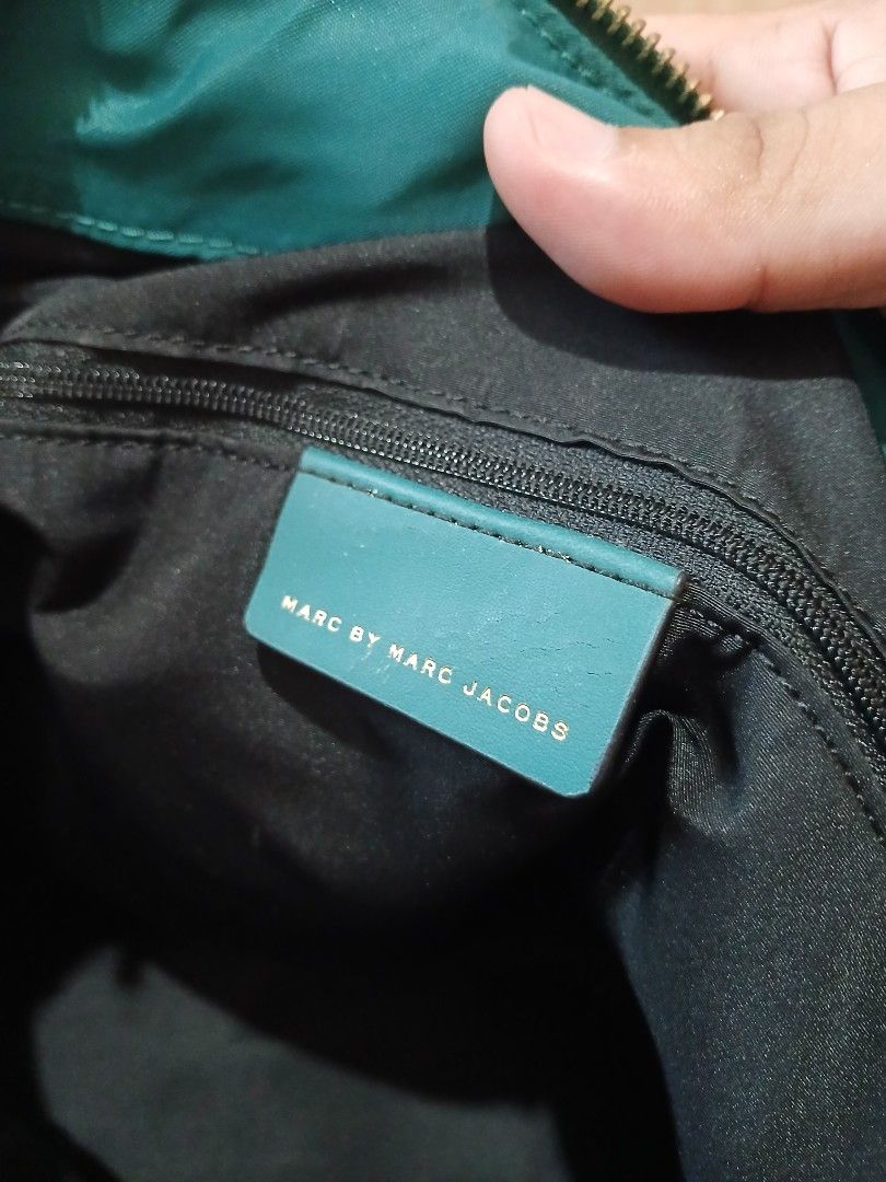 Marc by Marc Jacobs Nylon Tote Bag Teal (Category: Luxury Bags & Wallets) located in Daraga. Submitted by thethriftcity2024 (Listing ID 1463401504, Image 3). Description: - Brand: Marc by Marc Jacobs - Color: Teal - Material: Nylon with leather handles and trim - Closure: Zipper - Interior: 1 zipped pocket, 1 slip pocket - Origin: Made in the Philippines - Ideal for: Everyday use.
