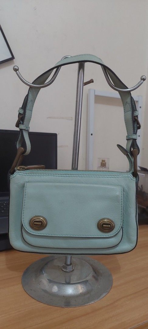 Marc Jacobs Light Blue Leather Shoulder Bag (Category: Luxury Bags & Wallets) located in Baguio. Submitted by lotus_blossom (Listing ID 1463553423, Image 1). Description: - Light blue leather shoulder bag - Brand: Marc Jacobs - Front flap with turn-lock closure - Zip-top main compartment - Suede interior lining - Brass hardware details - Classic shoulder bag design -FLAW slight difficulty in zipping and unzipping, needs oiling -Buyer shoulders sh