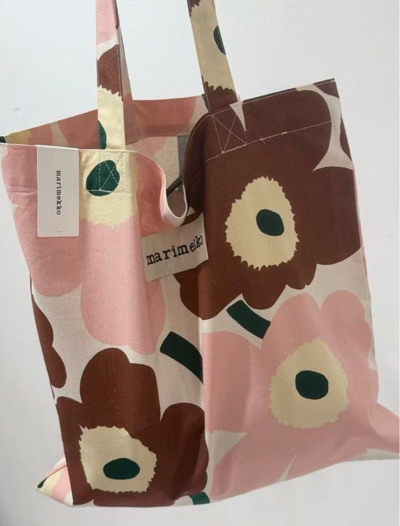 Marimekko Unikko Tote Bag (Category: Tote Bags) located in Makati City. Submitted by ciriacoria (Listing ID 1463332725, Image 3). Description: - Iconic Marimekko Unikko pattern tote bag - Features classic pink and brown flower print - Handles are also printed - Comes with a matching smaller pouch - Durable canvas material - Ideal for everyday use or travel.