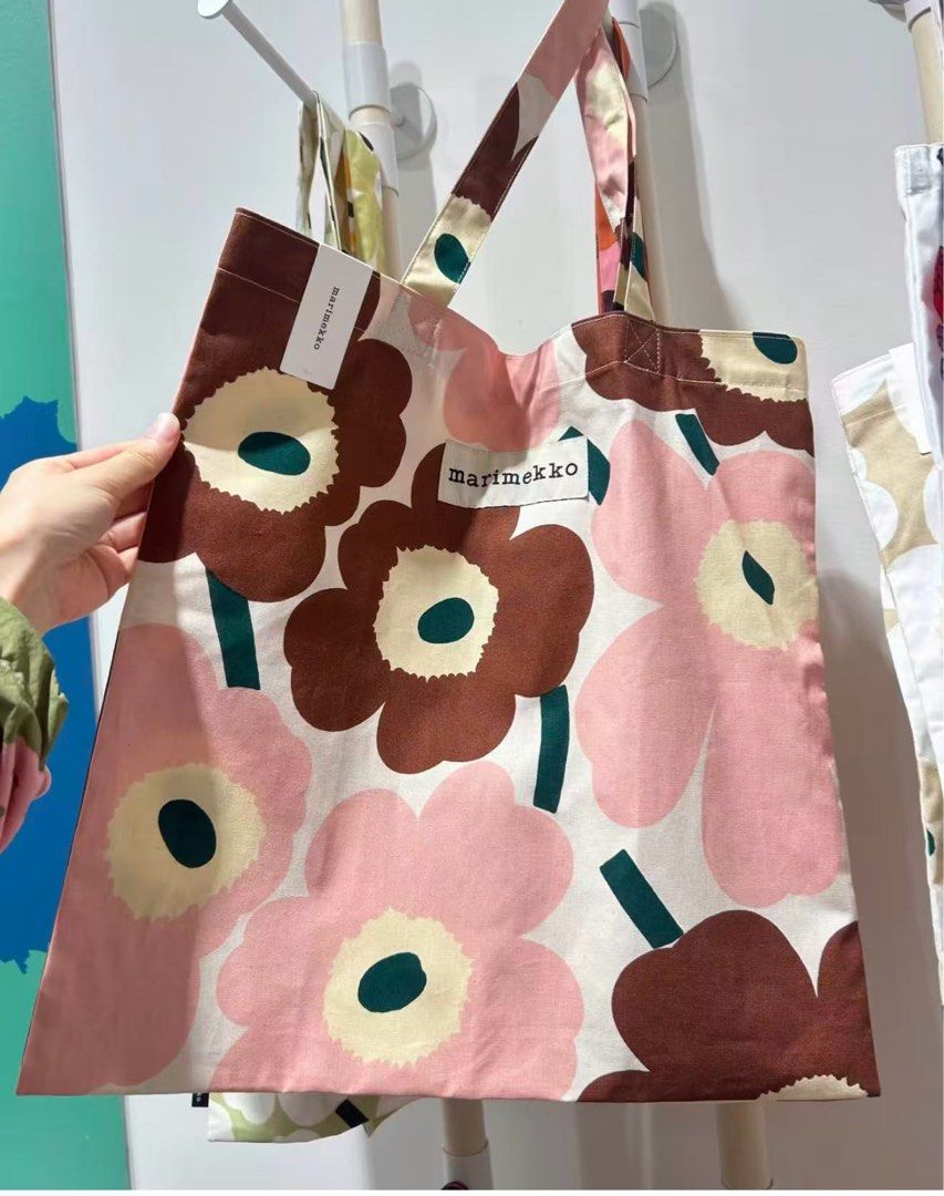 Marimekko Unikko Tote Bag (Category: Tote Bags) located in Makati City. Submitted by ciriacoria (Listing ID 1463332725, Image 2). Description: - Iconic Marimekko Unikko pattern tote bag - Features classic pink and brown flower print - Handles are also printed - Comes with a matching smaller pouch - Durable canvas material - Ideal for everyday use or travel.