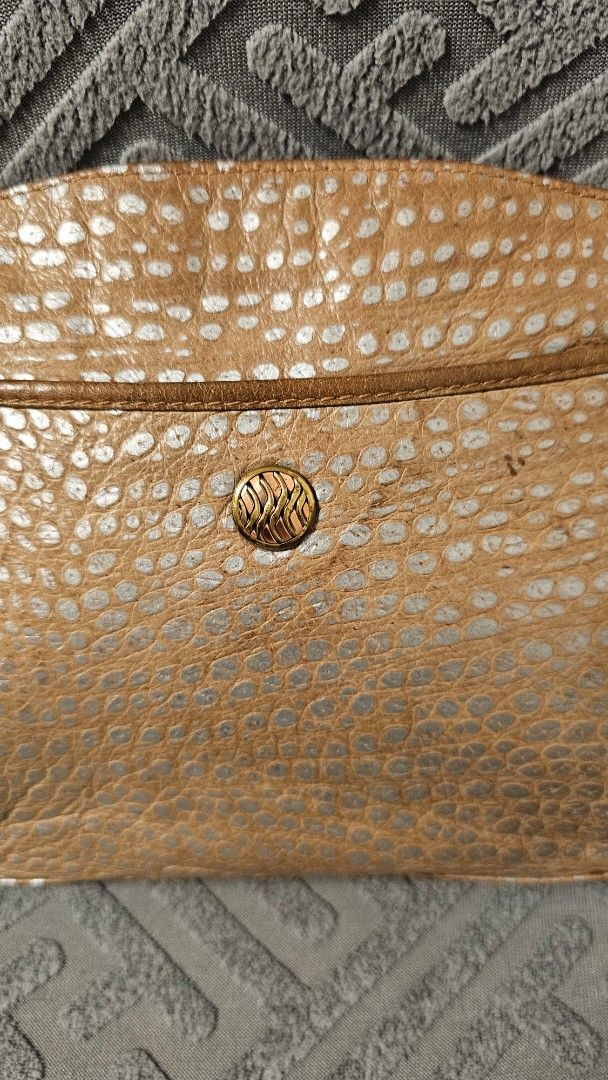 Mariotti Italy leather sling bag (Category: Cross-body Bags) located in Quezon City. Submitted by jollythrift (Listing ID 1463503314, Image 3). Description: - Small gold crossbody bag - Unique textured exterior with a distinct pattern - external side pocket - Zipper main closure and inside for your belongings - Ideal for carrying your daily essentials.