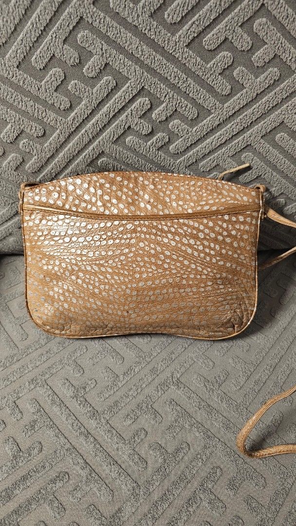 Mariotti Italy leather sling bag (Category: Cross-body Bags) located in Quezon City. Submitted by jollythrift (Listing ID 1463503314, Image 2). Description: - Small gold crossbody bag - Unique textured exterior with a distinct pattern - external side pocket - Zipper main closure and inside for your belongings - Ideal for carrying your daily essentials.