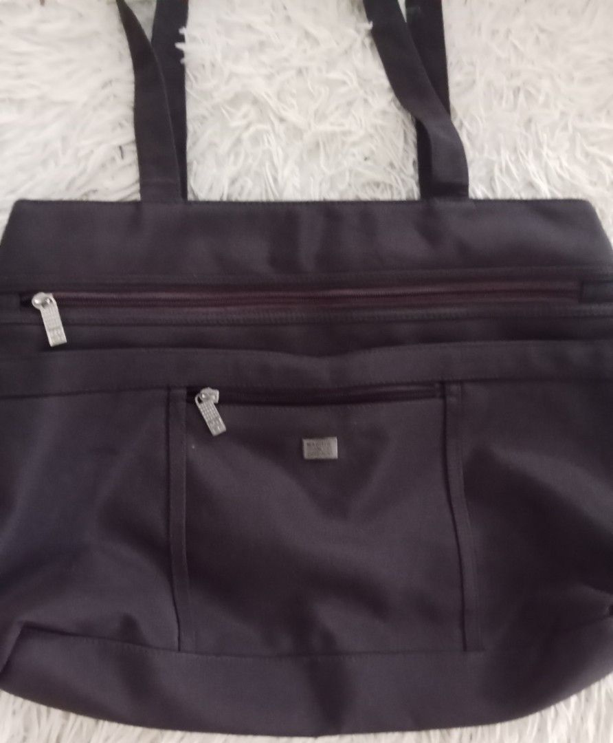 Marithe Francois Girbaud Tote Bag (Category: Tote Bags) located in Caloocan City. Submitted by noy5o1a (Listing ID 1463365800, Image 2). Description: - Dark brown Marithe Francois Girbaud tote bag - Main zippered compartment - Front zippered pocket - Smaller front pocket with magnetic closure - Comfortable strap length for carrying - Made of durable material - Plenty of space inside for essentials.