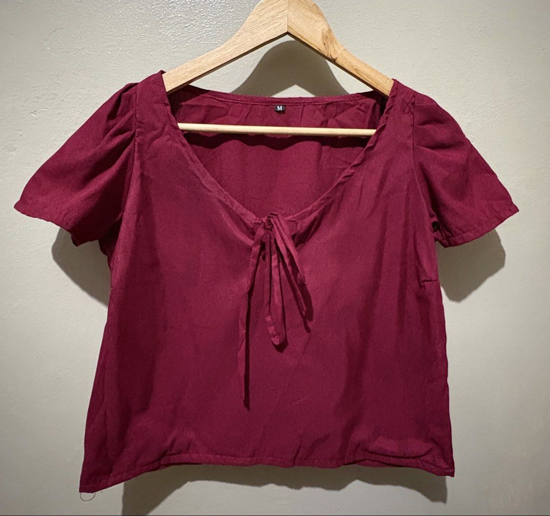 Maroon Puff Sleeve Tie-Front Top Size M (Category: Blouses) located in Manila. Submitted by stella_mari27 (Listing ID 1463431363, Image 1). Description: - Adorable maroon top with charming puff sleeves. - Features a stylish tie-front detail at the neckline. - Fabric boasts a lovely, unique texture. - Estimated size: Medium. - Versatile for both casual outings and dressing up..