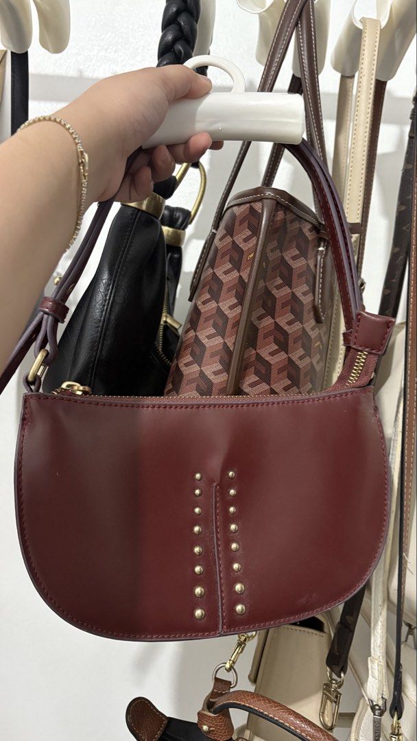Maroon Studded Shoulder Bag (Category: Shoulder Bags) located in Cavite. Submitted by aviahkesley (Listing ID 1463534810, Image 1). Description: - Cute maroon shoulder bag - Stylish gold stud details - Secure zipper closure - Adjustable strap for comfort - Fits perfectly under the arm - Versatile for everyday or evening wear - Easily matches various outfits.