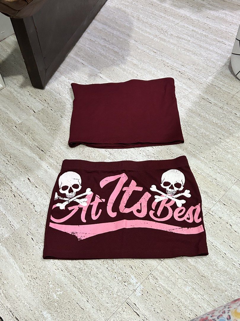 Maroon Tube Top only (Category: Sets or Coordinates) located in Batangas. Submitted by nommi26 (Listing ID 1463423832, Image 1). Description: - Maroon ribbed tube top - Matching maroon ribbed mini skirt - Features skull and 'At Its Best' graphic - Fun and edgy design, perfect for parties or a night out - Both top and skirt are stretchy for a comfortable fit.