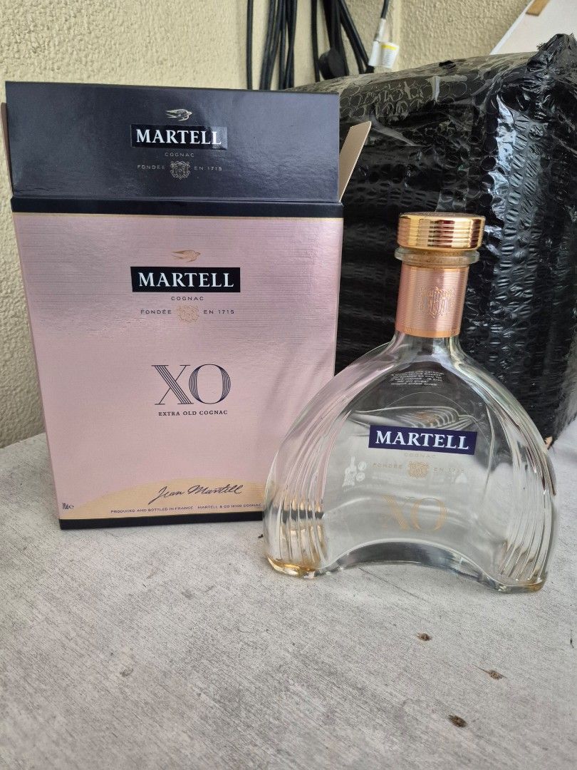 Martell XO Extra Old Cognac Empty Bottle with Box (Category: Beverages) located in Manila. Submitted by jayveecatu14021 (Listing ID 1463377427, Image 1). Description: Empty Martell XO cognac bottle. Comes with its original presentation box. The bottle has the distinctive XO shape. Box has some wear. Great for collectors or display. Selling as is..
