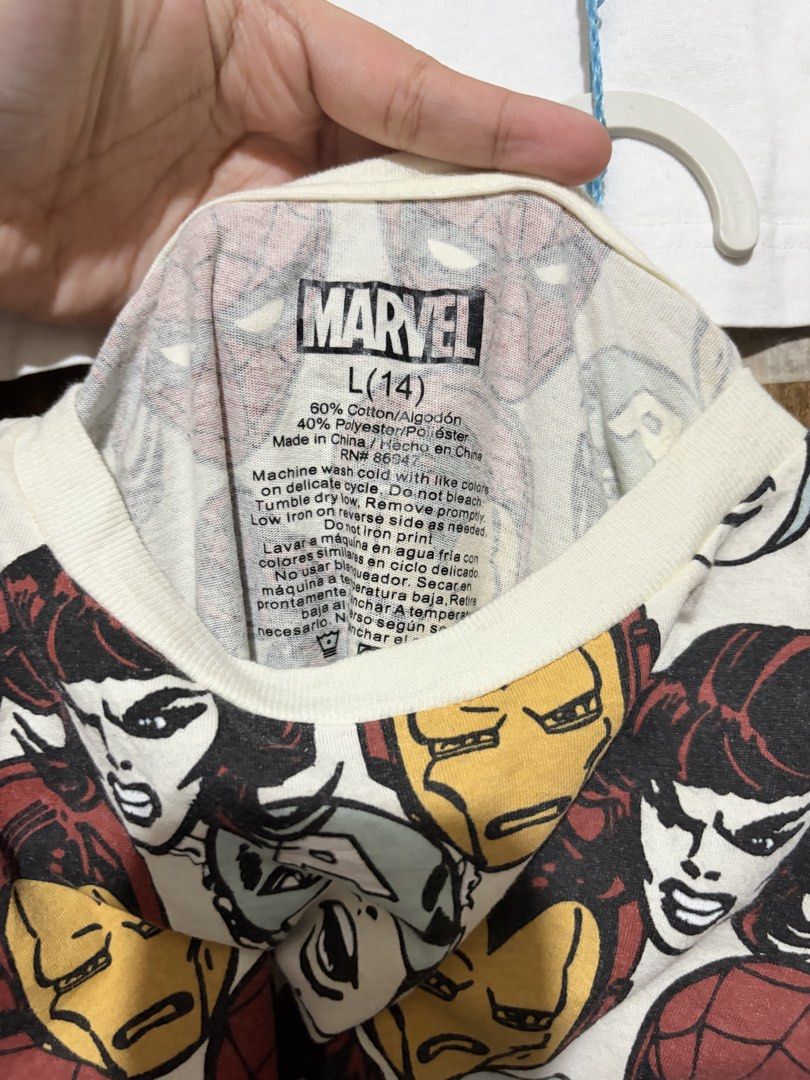 [MARVEL TEE] Marvel Comics All Over Print T-Shirt Size L(14) (Category: Tshirts & Polo Shirts ) located in Imus. Submitted by frootiloots4103 (Listing ID 1463333821, Image 2). Description: - Cool Marvel graphic tee - Features Iron Man, Captain America, and Spider-Man all-over print - Size: L (fits 14 years old) - Measurements: 19" wide x 23" long - Material: 60% Cotton, 40% Polyester - Ideal for any Marvel fan! OPEN FOR NEGO (best if aspack) 📍Im