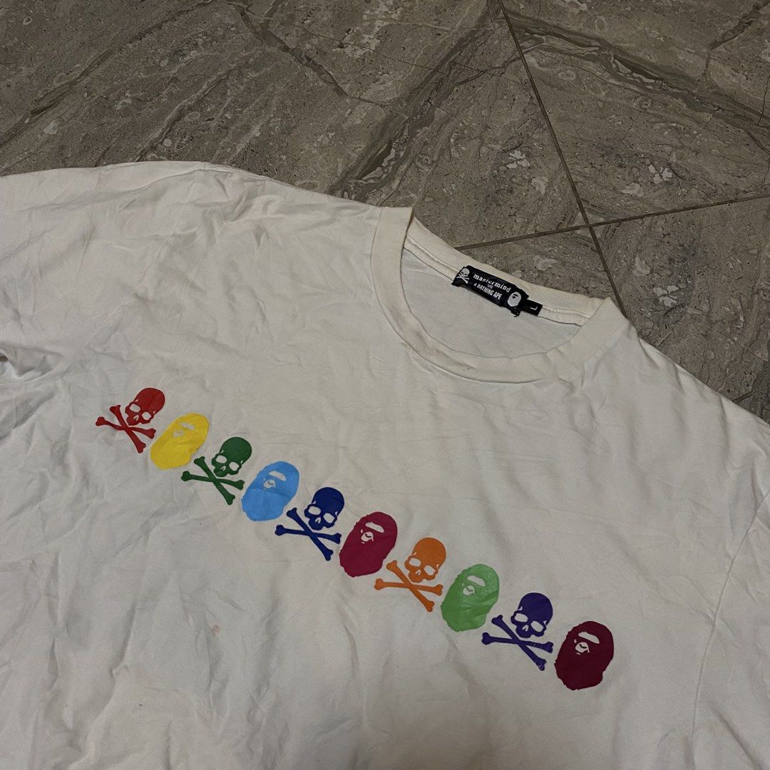 Mastermind Japan x A Bathing Ape Rainbow Skull Tee (Category: Tshirts & Polo Shirts ) located in Manila. Submitted by _vnnnsss (Listing ID 1463488965, Image 3). Description: - Mastermind Japan x A Bathing Ape collaboration tee - Features iconic rainbow skull and ape head graphic on the chest - "mastermind A BATHING APE" text in rainbow colors on the back - Size: Large (L) - Perfect for collectors of rare streetwear.