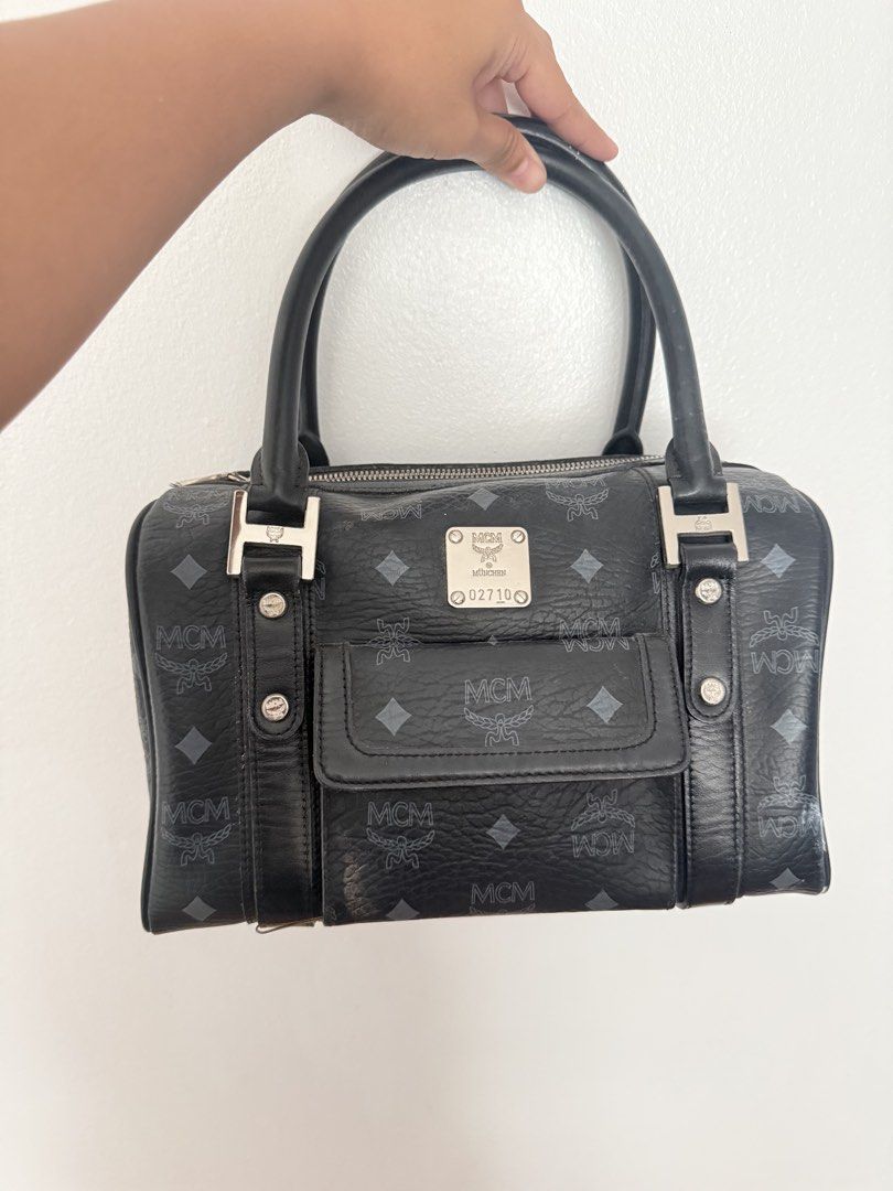 MCM Monogram Boston Bag Black Leather (Category: Luxury Bags & Wallets) located in Manila. Submitted by epicmoon_e05e67 (Listing ID 1463476041, Image 1). Description: - Classic MCM Boston bag - Black leather with signature MCM monogram print - Front pocket with snap closure - Top handles for carrying - Silver hardware details - Timeless and iconic piece Unli vc for legitimacy yes to lalamove / j&t condition: 8.5/10 will indicate via videocall if 