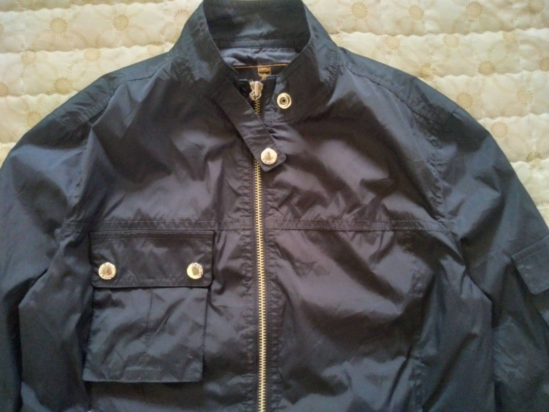 MCM Nylon Black Jacket Women (Category: Luxury Apparel) located in Zamboanga. Submitted by nurbya898048 (Listing ID 1463392310, Image 3). Description: Black nylon MCM jacket. Zip-up front with snap button pockets. Has a pocket on the left sleeve with a buckle closure. MCM logo details on the buttons and zipper pull. Great for casual wear. Tag size 90/medium Width 18 Length 21 Black color way Nylon/satin cloth In good condition Check all photos fo
