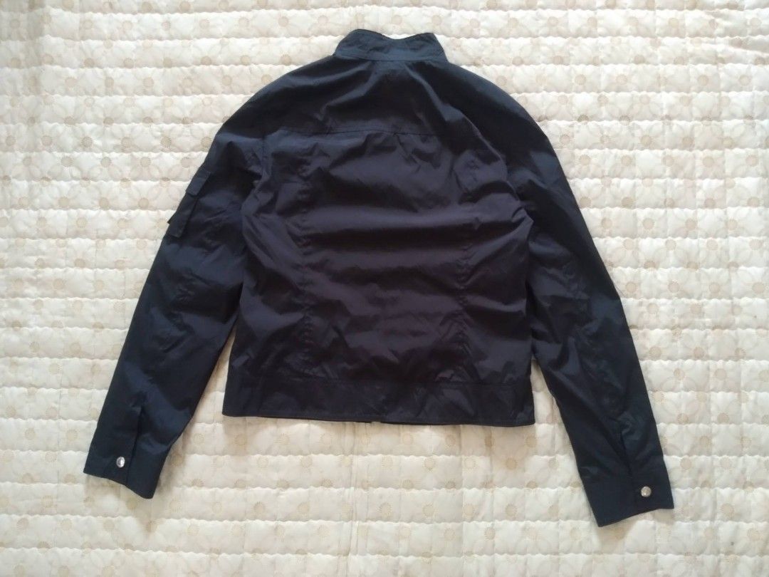 MCM Nylon Black Jacket Women (Category: Luxury Apparel) located in Zamboanga. Submitted by nurbya898048 (Listing ID 1463392310, Image 2). Description: Black nylon MCM jacket. Zip-up front with snap button pockets. Has a pocket on the left sleeve with a buckle closure. MCM logo details on the buttons and zipper pull. Great for casual wear. Tag size 90/medium Width 18 Length 21 Black color way Nylon/satin cloth In good condition Check all photos fo