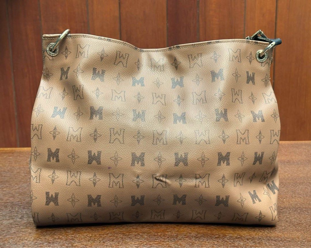 Metrocity shoulder bag (Category: Shoulder Bags) located in Bulacan. Submitted by thriftbagcollections (Listing ID 1463395936, Image 2). Description: Brown monogram Metrocity shoulder bag featuring a black leather handle and a dangling black tassel charm.Good condition with dents on edges only,Approx;H-10.5”W-16”D-5.5” handle 6”.