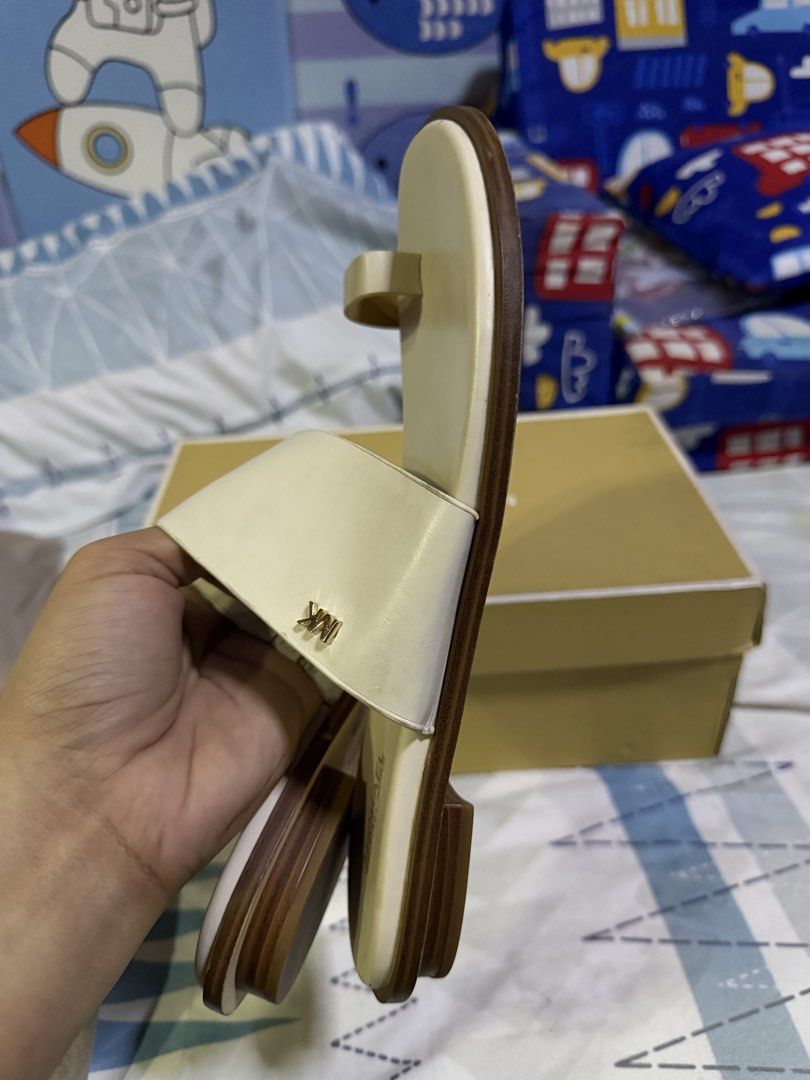 Michael Kors August Flat Sandals Cream US 8 (Category: Flats & Sandals) located in Pasig City. Submitted by aprilluxcloset0812 (Listing ID 1463478945, Image 3). Description: - Michael Kors August flat sandals - Color: Cream - Material: Leather upper - Design: Toe loop and wide strap with MK logo detail - Size: US 8 - Condition: Soles show some wear from use - Includes: Original box RFS: decluttering EVERYTHING MUST GO‼️Just make a reasonable offe