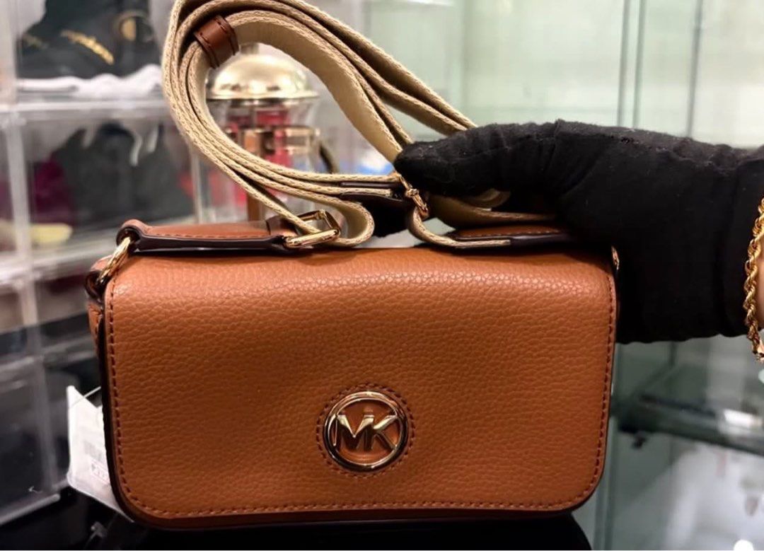 Michael Kors Brown Leather Crossbody Bag (Category: Cross-body Bags) located in Manila. Submitted by manyi04 (Listing ID 1463367301, Image 1). Description: - Brand: Michael Kors - Material: Brown pebbled leather - Hardware: Gold MK logo on front - Strap: Adjustable - Included: Care card - Ideal for: Everyday use.
