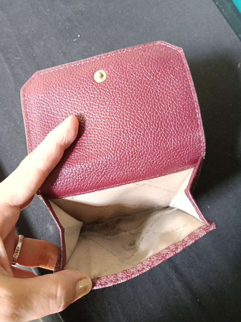 Michael Kors Burgundy Monogram Tri-Fold Wallet (Category: Wallets & Card holders) located in Antipolo. Submitted by vastgem_4c8da8 (Listing ID 1463352702, Image 2). Description: - Authentic Michael Kors tri-fold wallet in burgundy. - Features the iconic MK monogram pattern. - Multiple card slots for organization. - Includes a clear ID window. - Secure snap closure. - Please note: minor signs of wear inside, as shown in photos..