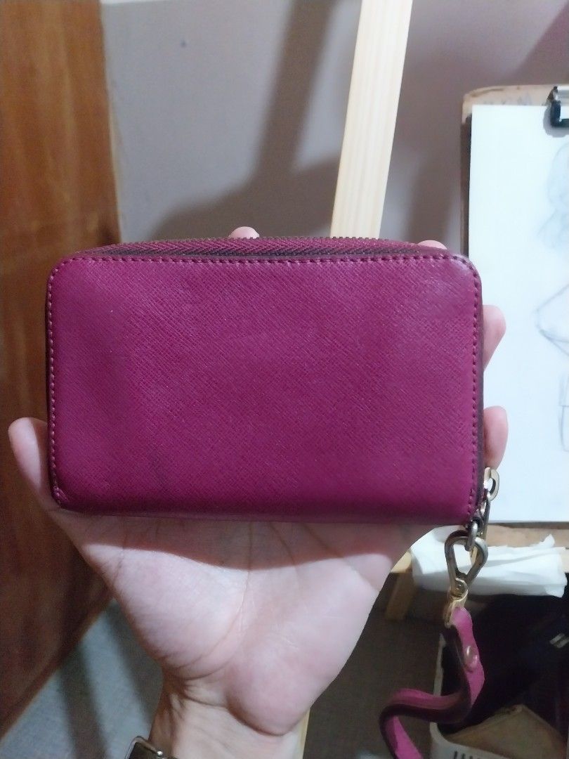 Michael Kors Jet Full zip Saffiano leather (Category: Wallets & Card holders) located in Manila. Submitted by j.dlh (Listing ID 1463355669, Image 2). Description: - Authentic Michael Kors Zip-Around Wallet - Color: Magenta - Material: Genuine Saffiano Leather - Hardware: Gold-tone - Interior: Multiple card slots and compartments - Closure: Zipper - Includes: Detachable wrist strap -has some faded hardware as expected due to age - little mark of u