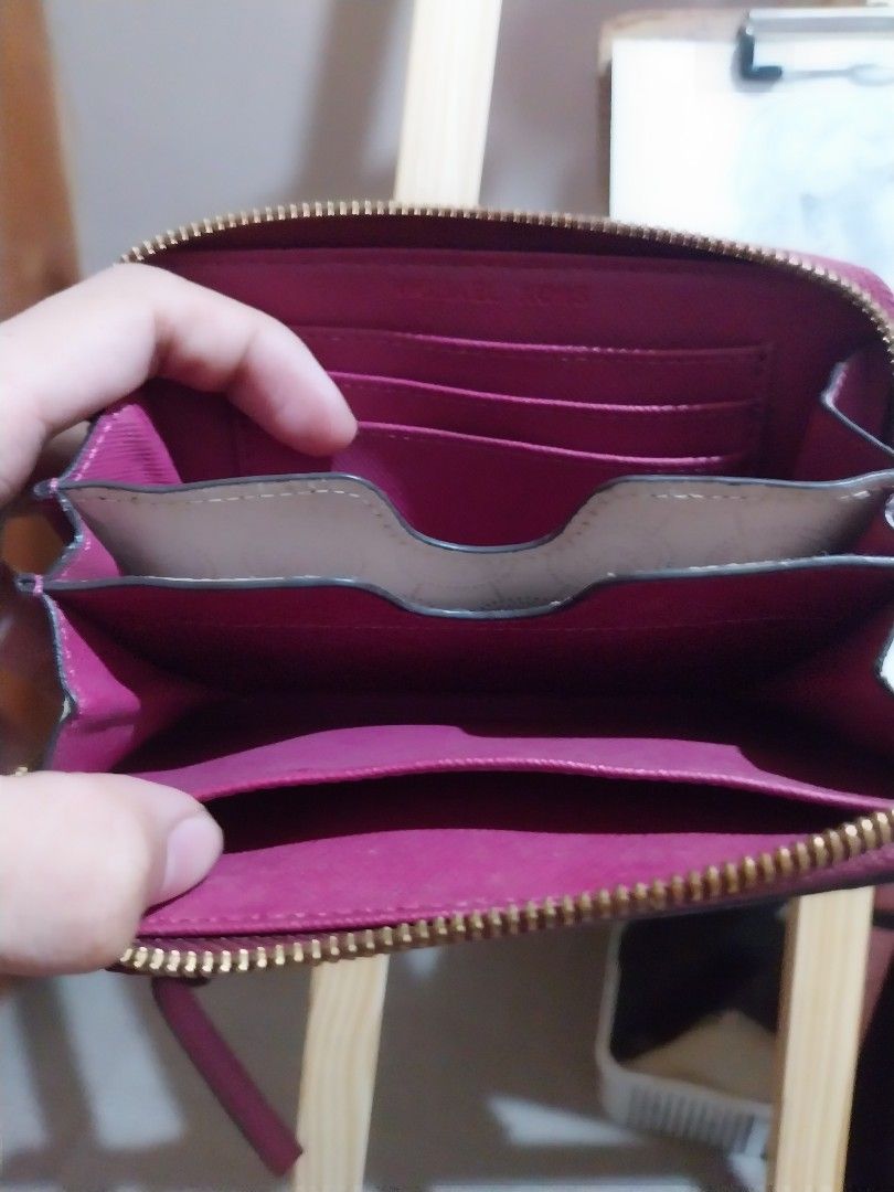 Michael Kors Jet Full zip Saffiano leather (Category: Wallets & Card holders) located in Manila. Submitted by j.dlh (Listing ID 1463355669, Image 3). Description: - Authentic Michael Kors Zip-Around Wallet - Color: Magenta - Material: Genuine Saffiano Leather - Hardware: Gold-tone - Interior: Multiple card slots and compartments - Closure: Zipper - Includes: Detachable wrist strap -has some faded hardware as expected due to age - little mark of u