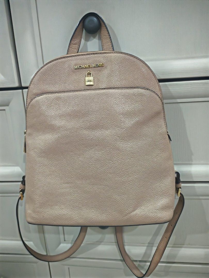 Michael Kors Leather Backpack - Beige (Category: Luxury Bags & Wallets) located in Manila. Submitted by jeraldliam77253 (Listing ID 1463354865, Image 1). Description: - Genuine Michael Kors leather backpack - Stylish beige color, versatile for any outfit - Front zip pocket for quick access - Spacious main compartment - Interior zip pocket and slip pockets for organization - Elegant gold hardware details - Adjustable straps for comfortable wear - 