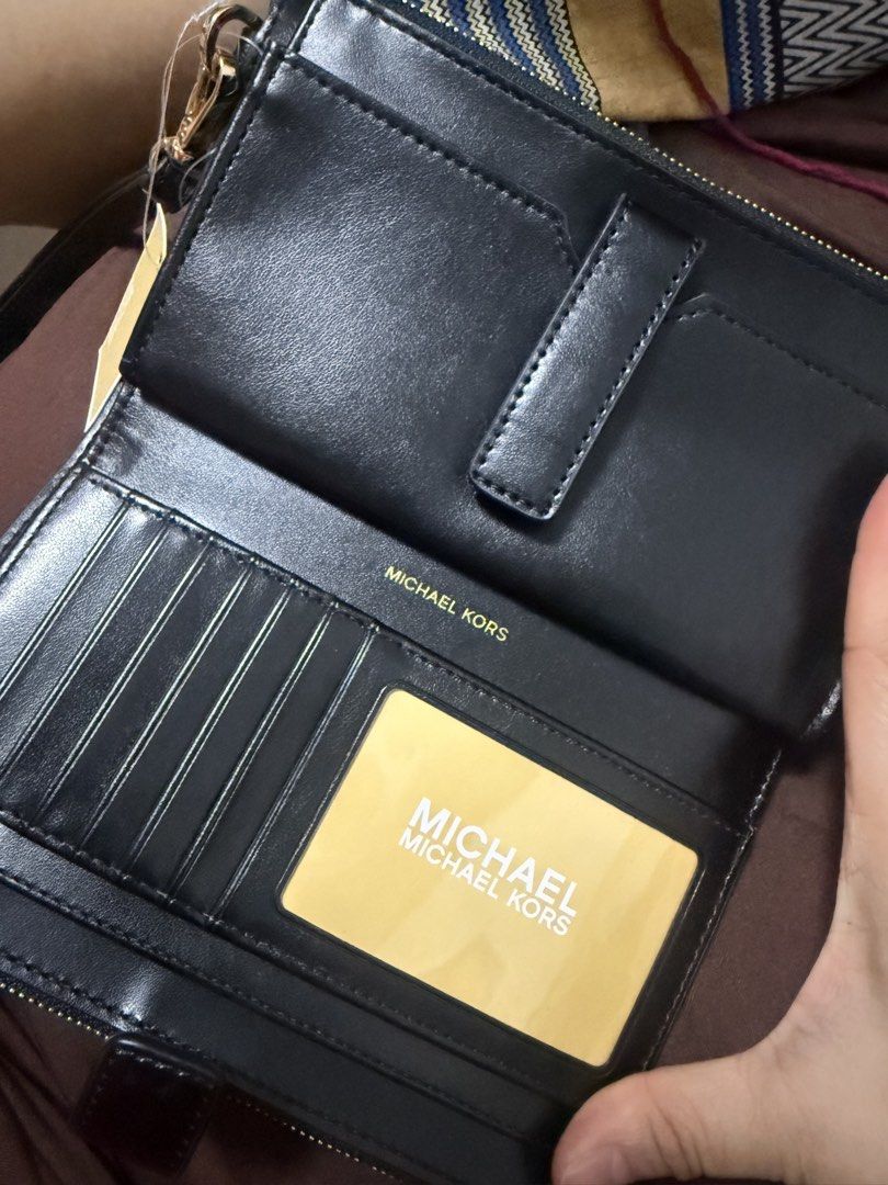 Michael Kors Leather Top Zip Wristlet Black (Category: Wallets & Card holders) located in Makati City. Submitted by jelqtee (Listing ID 1463328941, Image 2). Description: Michael Kors black pebbled leather wristlet with zip-around closure. Features card slots, ID window, and gold-tone hardware. Includes care cards. Bought from 🇨🇦.