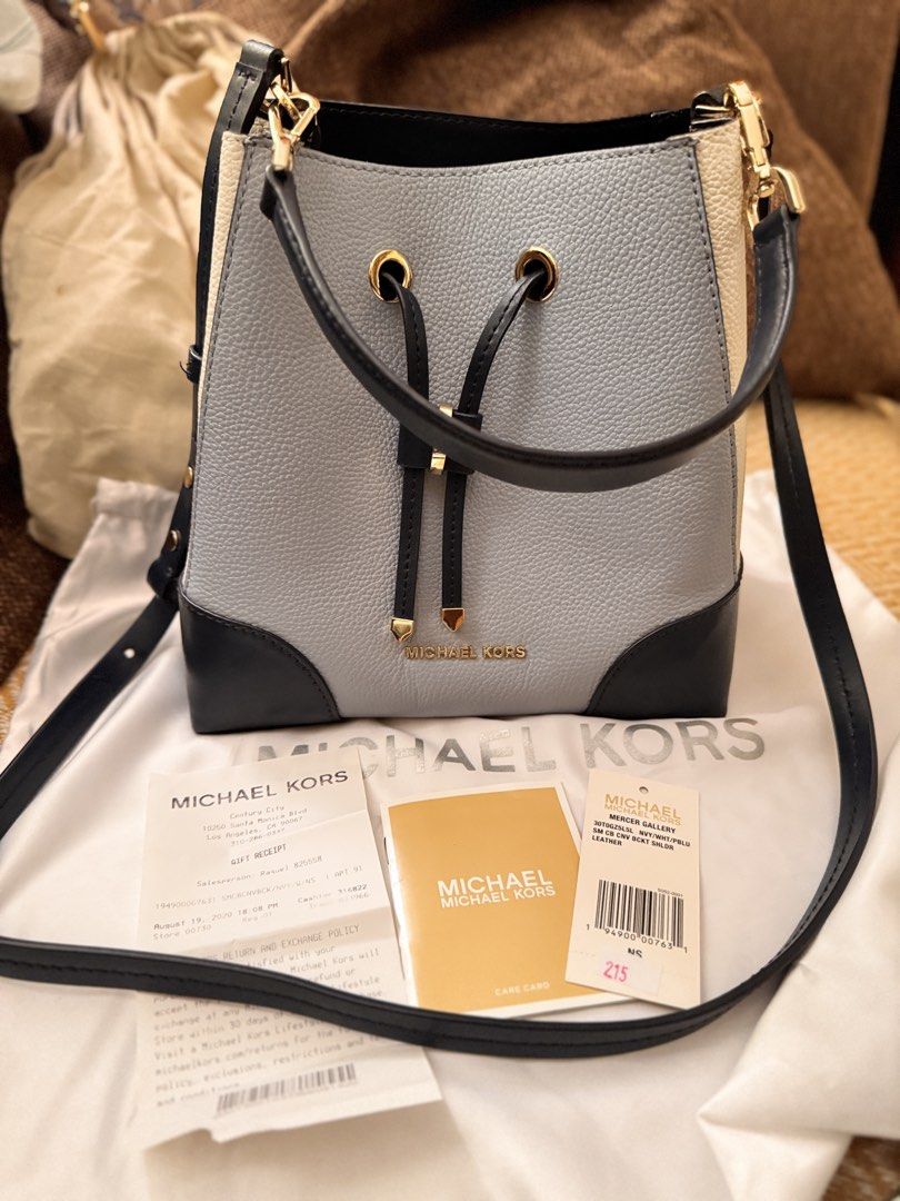 Michael Kors Mercer Gallery Bucket Bag (Category: Luxury Bags & Wallets) located in Bacoor. Submitted by marylhouis38757 (Listing ID 1463397545, Image 2). Description: - Authentic Michael Kors Mercer Gallery bucket bag - Color: Light blue and cream with navy trim - Closure: Drawstring - Strap: Crossbody - Includes: Dust bag, care card, original receipt - Ideal for: Everyday use.