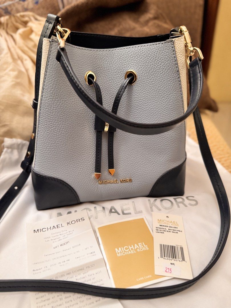 Michael Kors Mercer Gallery Bucket Bag (Category: Luxury Bags & Wallets) located in Bacoor. Submitted by marylhouis38757 (Listing ID 1463397545, Image 1). Description: - Authentic Michael Kors Mercer Gallery bucket bag - Color: Light blue and cream with navy trim - Closure: Drawstring - Strap: Crossbody - Includes: Dust bag, care card, original receipt - Ideal for: Everyday use.
