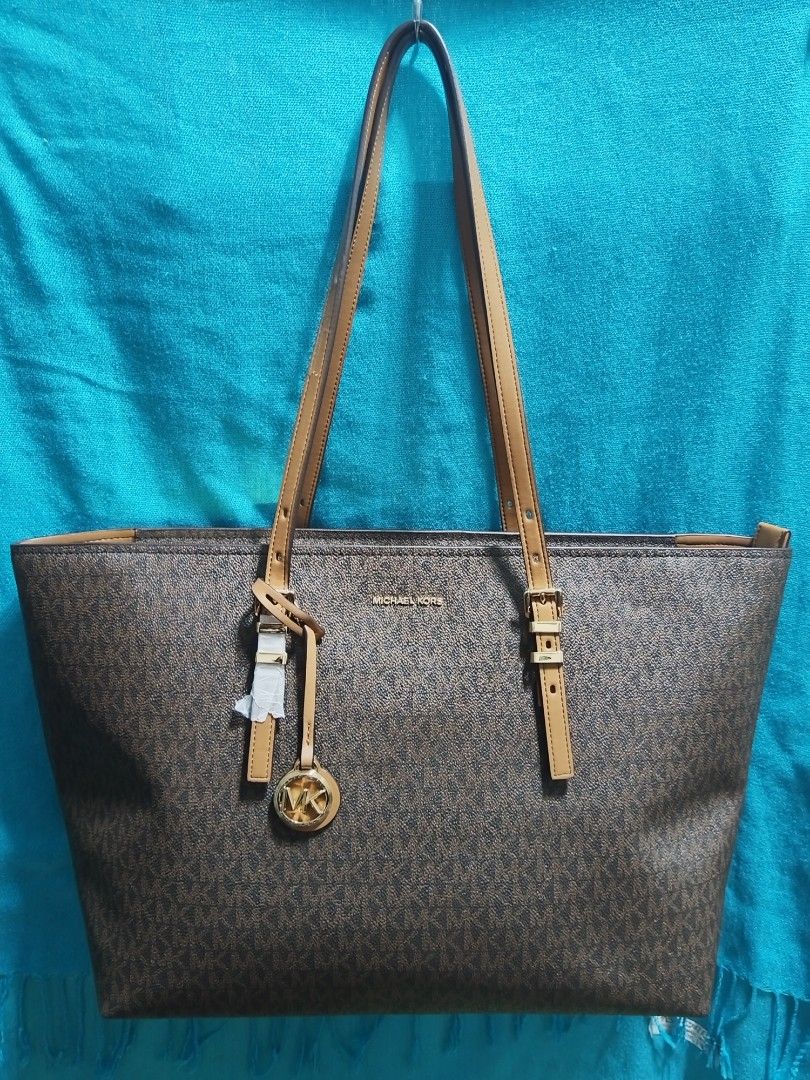 Michael Kors Monogram Tote Bag Brown (Category: Luxury Bags & Wallets) located in Caloocan City. Submitted by jpmshoppe (Listing ID 1463362770, Image 1). Description: - Authentic Michael Kors tote bag - Signature brown monogram print - Tan leather straps and trim - Secure zipper closure for main compartment - Interior zip pocket and slip pockets - Made in Indonesia - Comes with original tags.