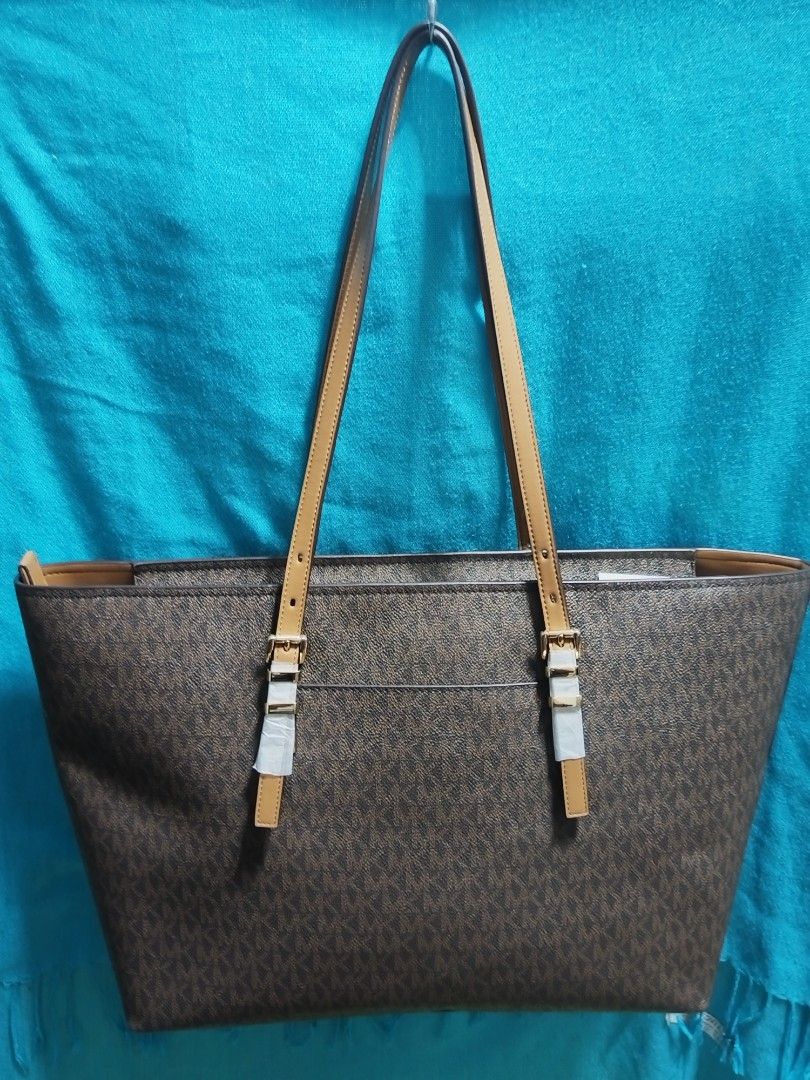 Michael Kors Monogram Tote Bag Brown (Category: Luxury Bags & Wallets) located in Caloocan City. Submitted by jpmshoppe (Listing ID 1463362770, Image 2). Description: - Authentic Michael Kors tote bag - Signature brown monogram print - Tan leather straps and trim - Secure zipper closure for main compartment - Interior zip pocket and slip pockets - Made in Indonesia - Comes with original tags.