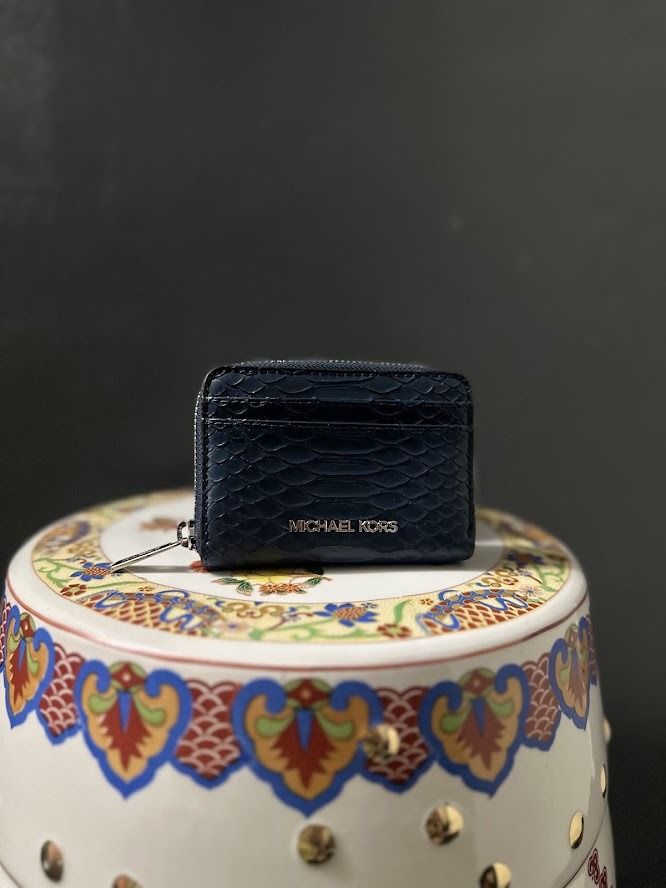 Michael Kors Navy Blue Snake Embossed Card Holder (Category: Wallets & Card holders) located in Caloocan City. Submitted by zealgem_d3432f (Listing ID 1463528443, Image 1). Description: - Brand: Michael Kors - Color: Navy Blue - Material: Snake embossed texture - Closure: Zip closure - Features: Front card slot - Hardware: Silver tone - Size: Small and compact, ideal for essentials Please feel free to message me if there are any inquiries or requ