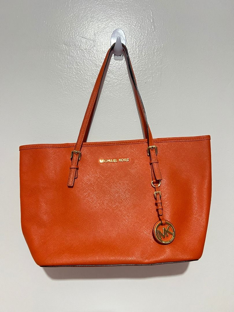 Michael Kors Orange Leather Tote Bag (Category: Luxury Bags & Wallets) located in Caloocan City. Submitted by jpnusapasabuyfindsdvo (Listing ID 1463515634, Image 2). Description: Michael Kors Jet Set Travel Medium Saffiano Leather Tote (Orange) - Authentic Orange Michael Kors tote bag - Genuine leather material - Elegant gold hardware details - Iconic MK charm hanging from the strap - Very spacious interior, ideal for everyday essentials - Meticu